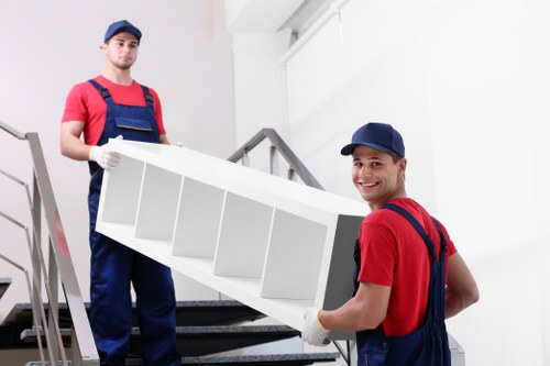A moving team handling household items in a Nottinghill property