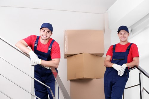 Supervised removals team managing packed furniture safely
