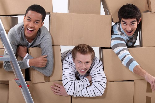 Professional movers carrying boxes in Notting Hill street