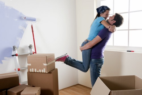 Professional movers handling office equipment and boxes in a Notting Hill street