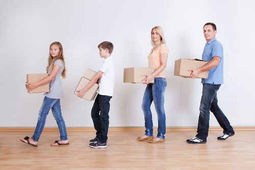 Movers carrying furniture through a Notting Hill property staircase